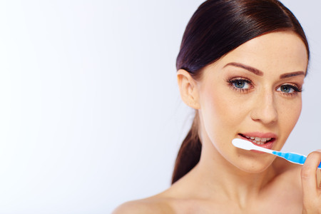 young woman with a toothbrush. in studioの写真素材