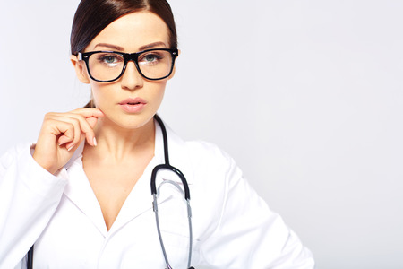 Medical doctor woman in a white studioの写真素材