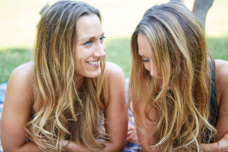 Two Female Friends Enjoying Picnic Together in Natureの写真素材