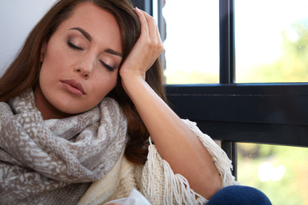 Flu. Closeup image of frustrated sick woman with red noseの写真素材