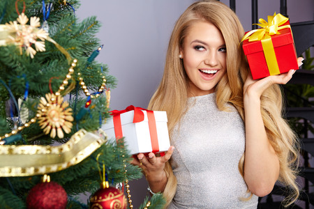 bright picture of woman decorating christmas treeの写真素材