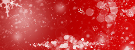 a red christmas background with some snowflakesの写真素材