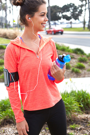 Beautiful fitness athlete woman drinking water after work outの写真素材