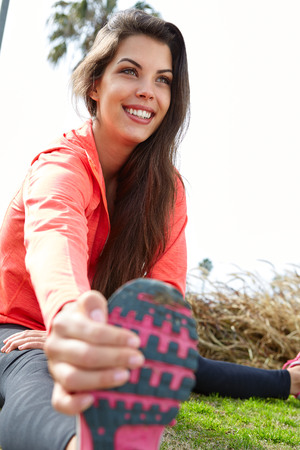 Young sportswoman stretching and preparing to run.の写真素材