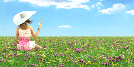 Spring woman with a hat laying in a field of flowers. 3d renderingの写真素材