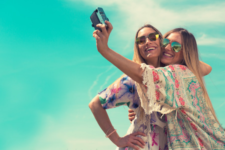 portrait of a beautiful young female twins. selfie conceptの写真素材