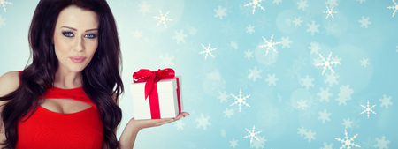 Beautiful woman portrait hold gift in christmas color style . Smiling happy girl on blue background.