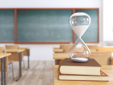 sandglass on books in empty school classroom. 3d renderingの写真素材