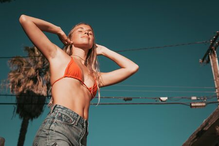 young woman with a bikini and shorts. california lifestyleの写真素材