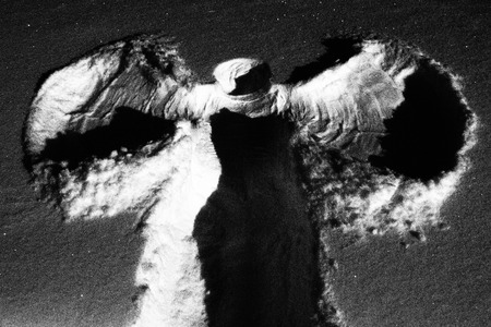 Artistic black and white photograph of snow angelの写真素材