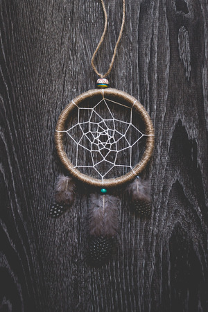 Dreamcatcher on the dark wooden surfaceの写真素材