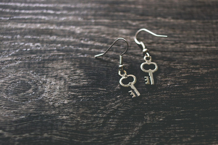 Silver key earringsの写真素材