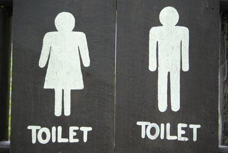 Ancient toilet sign on woodの写真素材