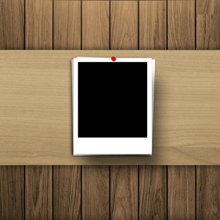 blank photo frame on wooden texture backgroundの写真素材