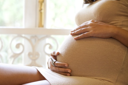 Image of pregnant woman touching her belly with handsの写真素材