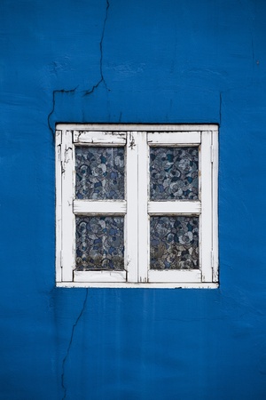 Blue wall with retro windowの写真素材