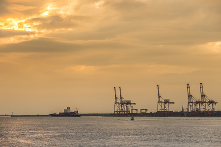Container stacks and crane in shipyard at sunset for cargo Goods and Logistic のeditorial素材