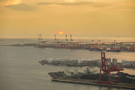 Container stacks and crane in shipyard at sunset for cargo Goods and Logistic のeditorial素材