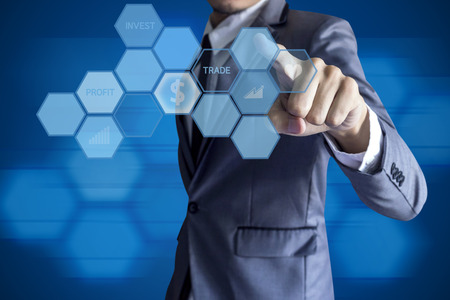 Business man touch modern interface for invesment on blue background.の写真素材