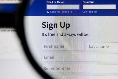 THAILAND - SEPTEMBER 2, 2014: Magnifying glass of Facebook page view on web browser.のeditorial素材