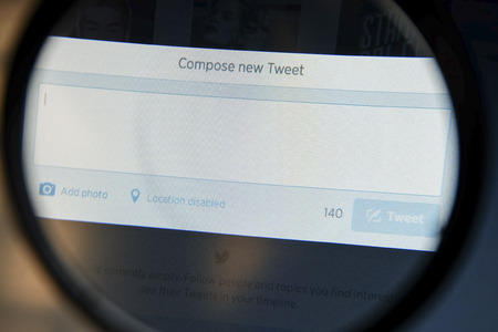 THAILAND - SEPTEMBER 2, 2014: Magnifying glass of twitter page compose new tweet view on web browser.のeditorial素材