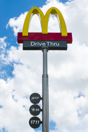 THAILAND - SEPTEMBER 04, 2014: McDonalds logo on blue sky background. It is the world's largest fast food chain, over 31,000 restaurants worldwide, serve 58 million customers each dayのeditorial素材