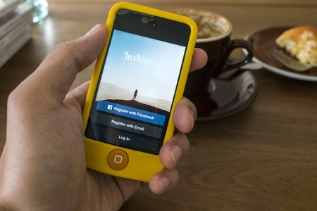 THAILAND - SEPTEMBER 05, 2014: Instagram login screen application on ipod apple product with wood backgroundのeditorial素材