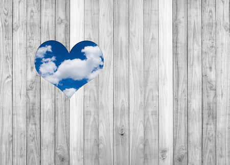 White wood plank wall texture background with sky inside heart shapeの写真素材