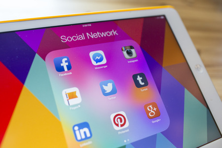 CHIANG MAI, THAILAND - SEPTEMBER 07, 2014: All of popular social media icons on Apple new iPad Air device screen wood background.のeditorial素材