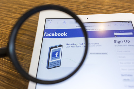 CHIANG MAI, THAILAND - SEPTEMBER 17, 2014: Magnifying glass of Facebook page view on web browser...