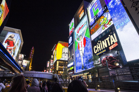 OSAKA, JAPAN - OCTOBER 28, 2013: The famed advertisements of Dotonbori. With a history reaching back to 1612, the districtis now one of Osaka's primary tourist destinations.のeditorial素材