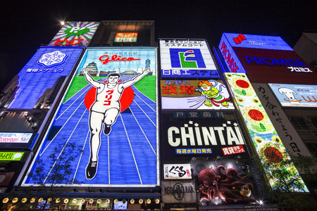OSAKA, JAPAN - OCTOBER 28, 2013: The famed advertisements of Dotonbori. With a history reaching back to 1612, the districtis now one of Osaka's primary tourist destinations.のeditorial素材