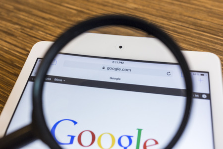 CHIANG MAI, THAILAND - SEPTEMBER 17, 2014: Magnifying glass of Google search page view on web...