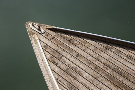 head of boat floats near the shoreの写真素材