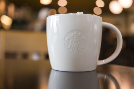 CHIANG MAI, THAILAND - OCTOBER 02, 2014: Starbucks coffee caramel latte white mug in Starbucks Cafe Chiang Mai Thailand. Starbucks is the largest coffeehouse company in the world.のeditorial素材