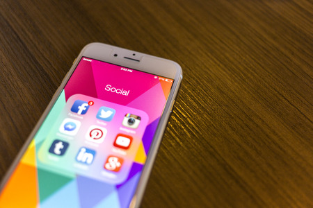 CHIANG MAI, THAILAND - JANUARY 02, 2015: All of popular social media icons on smartphone device screen with hand holding on Apple iPhone 6.のeditorial素材