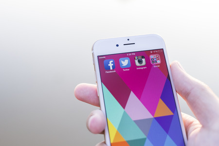 CHIANG MAI, THAILAND - JANUARY 02, 2015: All of popular social media icons on smartphone device screen with hand holding on Apple iPhone 6.のeditorial素材