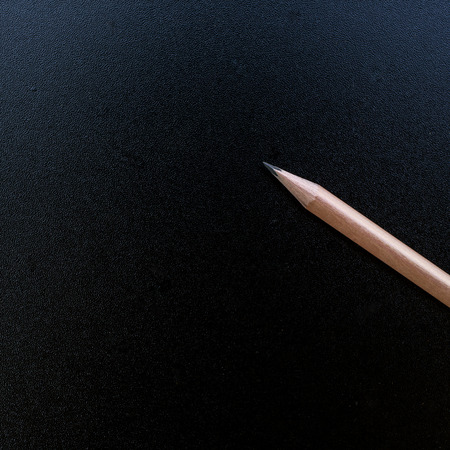 Wood pencil on blank blackboard