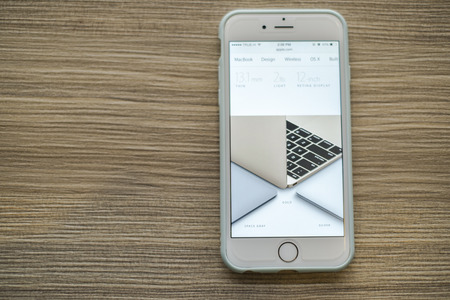 CHIANG MAI, THAILAND - March 10, 2015: Apple Computers website close up details on Apple iPhone 6 with the New Macbook Apple laptop.のeditorial素材