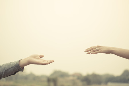 Couple hand together touch with love vintage filter tone.の写真素材