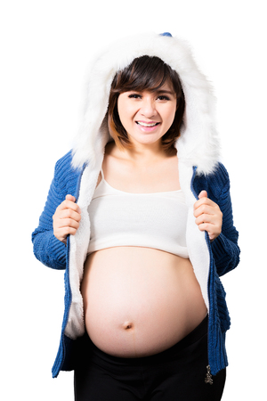 Portrait of the beautiful 9 month pregnant woman happy posing isolated on white backgroundの写真素材