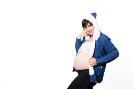 Portrait of the beautiful 9 month pregnant woman happy posing isolated on white backgroundの写真素材