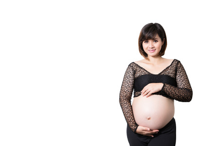 Portrait of the beautiful 9 month pregnant woman happy posing isolated on white background.の写真素材