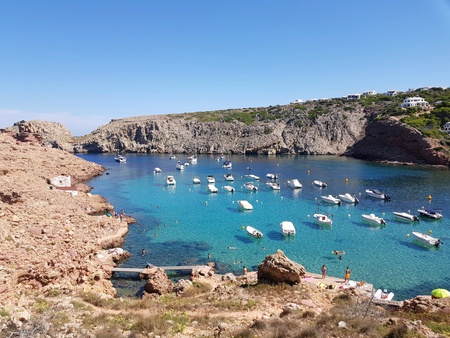 Water turquoise with boat, Cala morell, Minorcaの素材