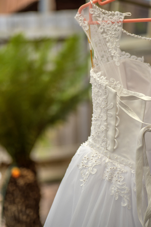 White wedding dress hanging waiting for wedding.の写真素材