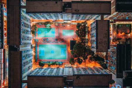 Aerial view of intersection in Hong Kong Downtown. Financial district and business centers in smart city, technology concept. Top view of buildings at night.の写真素材