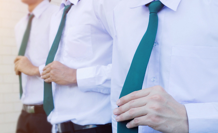 Close-up of a businessman adjusting his necktieの写真素材
