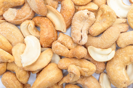 Roasted salted cashews, isolated on a white backgroundの写真素材