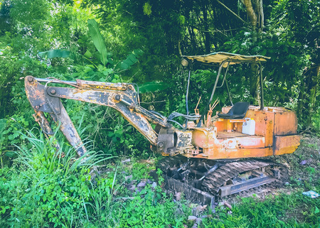 Old rusty excavator in the forestの写真素材