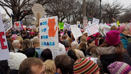 WASHINGTON, DC - JANUARY 21, 2017: Protesters hold up anti-Trump signs as thousands participate in the Women's March on Washington for social justice, the day after the Presidential Inauguration.のeditorial素材